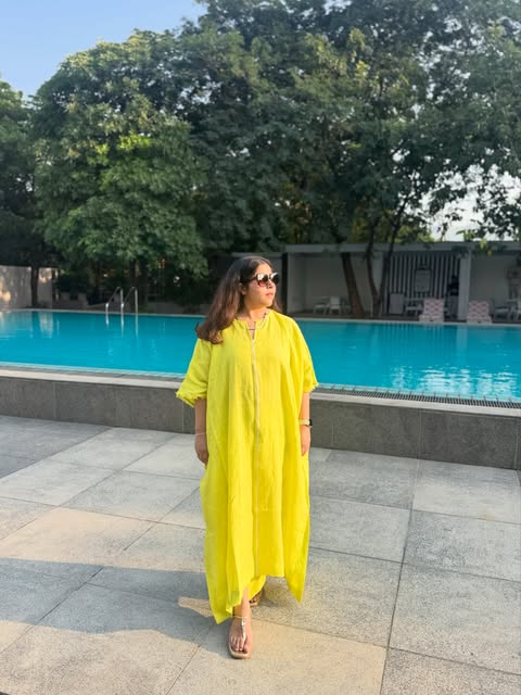 Flowing yellow linen kaftan by the pool